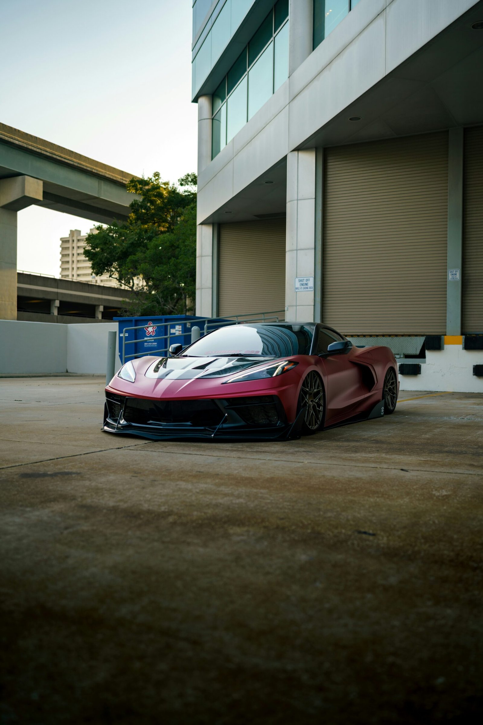 a red sports car parked in front of a building